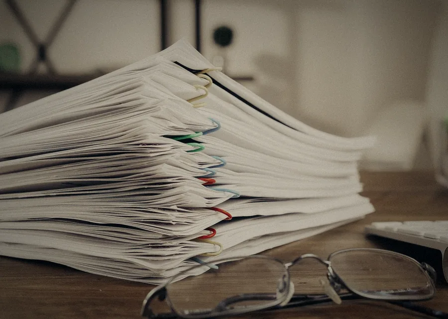 Stacks of reports on a desk
